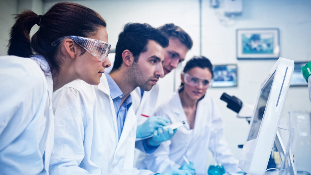 Scientists looking at a monitor in a lab
