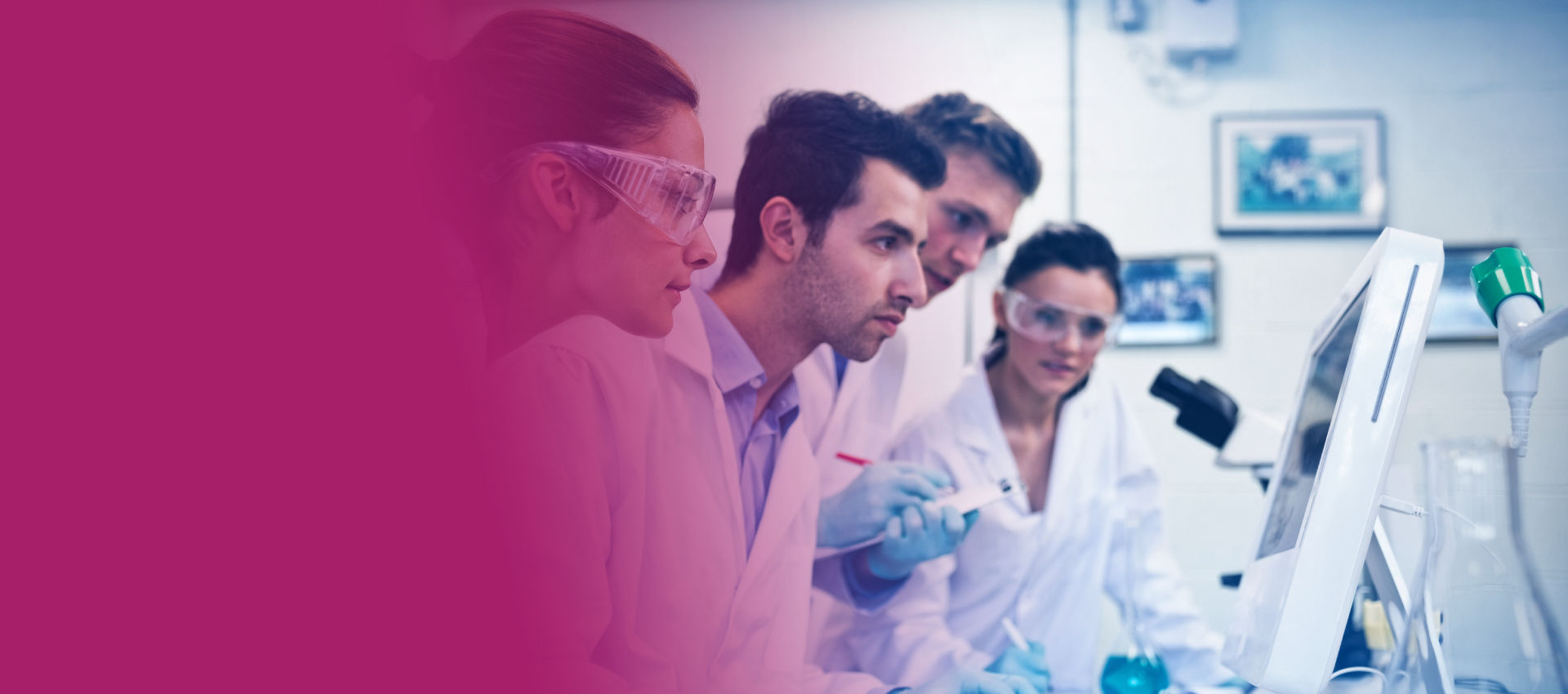 Scientists looking at a monitor in a lab